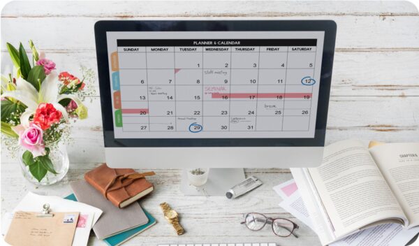 A computer monitor showing a content schedule calendar for blog posts.